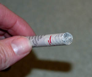 roll newspaper tightly